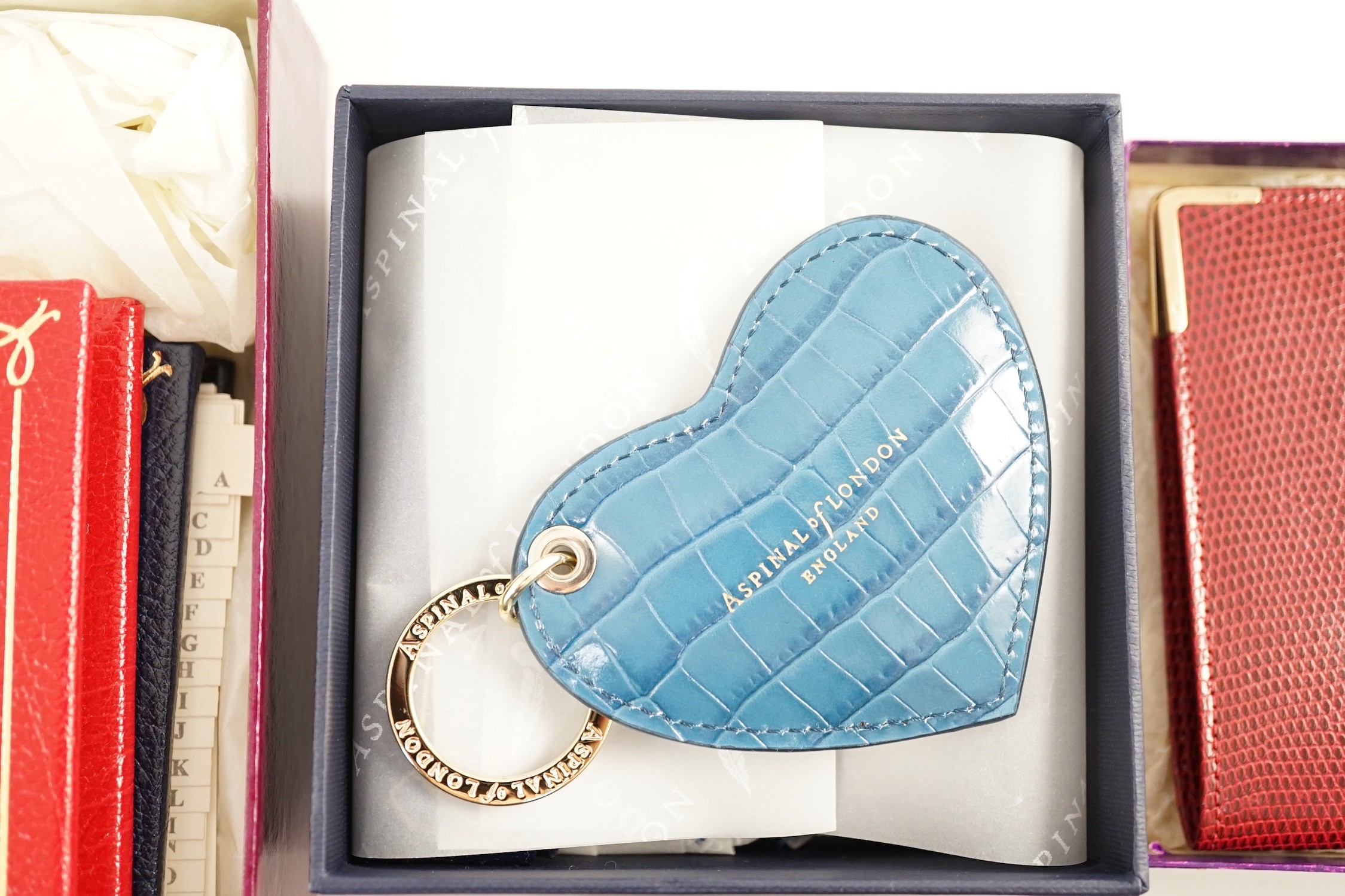 A set of two Asprey leather address books (initialled), an Asprey snakeskin wallet, a Loewe brown leather wallet and an Aspinal heart key fob
